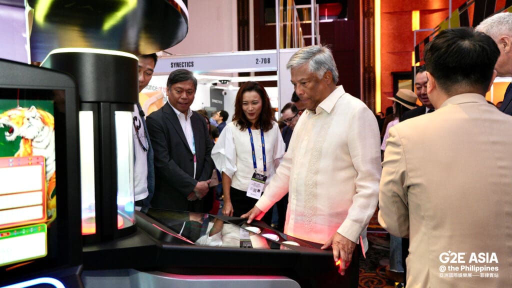 Industry leaders and officials viewing a gaming machine at the G2E Asia @ the Philippines exhibition opening in Manila