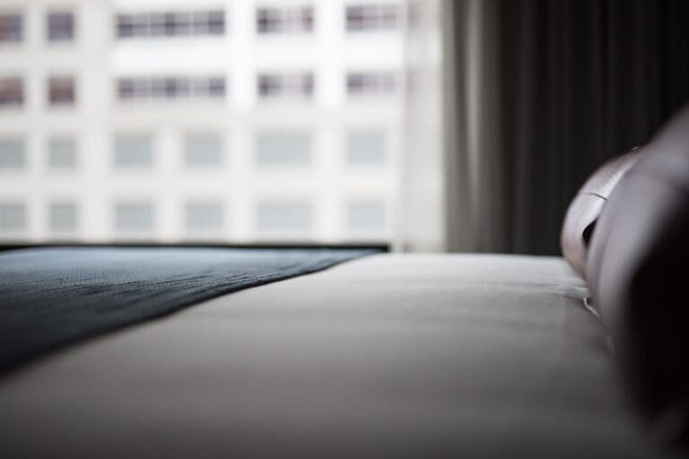 Calm, neatly made bed in a soft, quiet room suitable for restful sleep