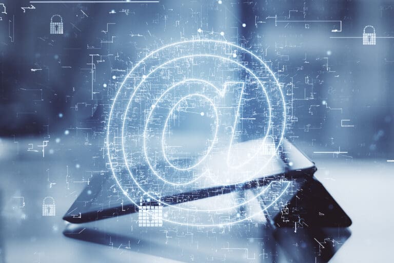Digital @ symbol over a tablet.